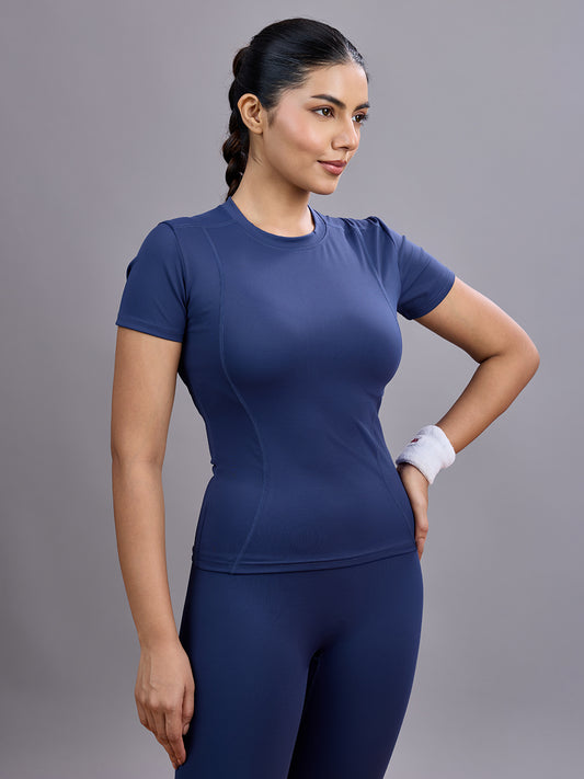 Woman wearing a blue athletic outfit on a gray background